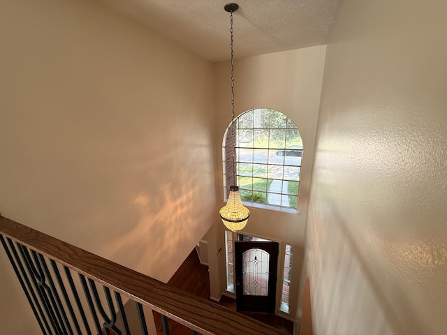 9619 Therrell Dr, Houston, TX 77064 - stairs featuring wood finished floors, baseboards, and a textured ceiling