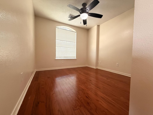 9619 Therrell Dr, Houston, TX 77064 - spare room with dark wood finished floors, ceiling fan, baseboards, and a textured wall