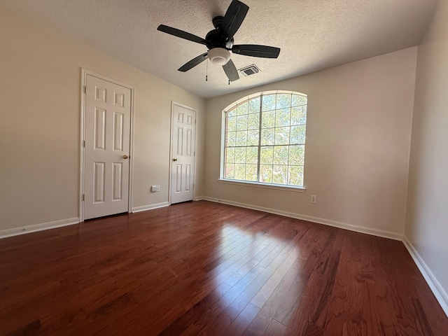 9619 Therrell Dr, Houston, TX 77064 - unfurnished bedroom featuring a textured ceiling, dark wood-style flooring, baseboards, and ceiling fan