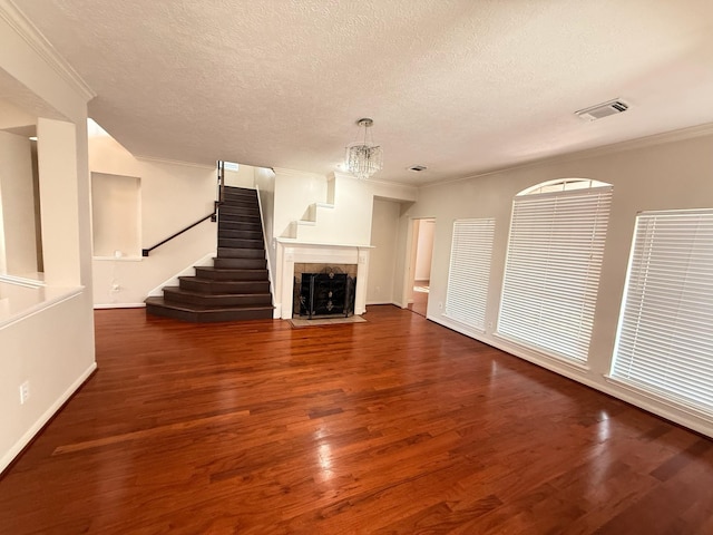 9619 Therrell Dr, Houston, TX 77064 - unfurnished living room with wood finished floors, ornamental molding, a textured ceiling, stairs, and baseboards