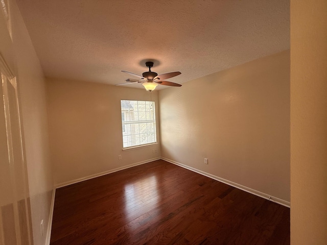 9619 Therrell Dr, Houston, TX 77064 - spare room featuring dark wood-style floors, a textured ceiling, ceiling fan, and baseboards