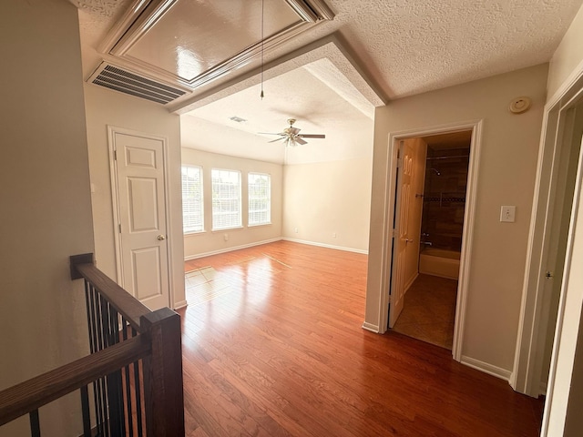 9619 Therrell Dr, Houston, TX 77064 - empty room featuring wood finished floors, a textured ceiling, baseboards, and ceiling fan
