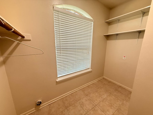9619 Therrell Dr, Houston, TX 77064 - washroom featuring baseboards and light tile patterned floors