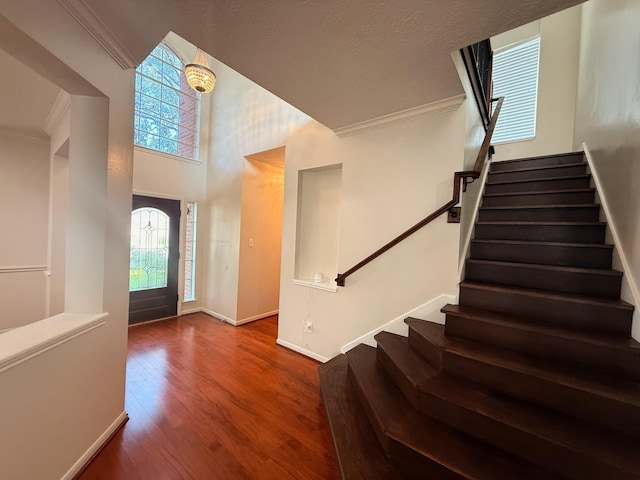 9619 Therrell Dr, Houston, TX 77064 - entryway featuring stairway, plenty of natural light, crown molding, wood finished floors, and baseboards