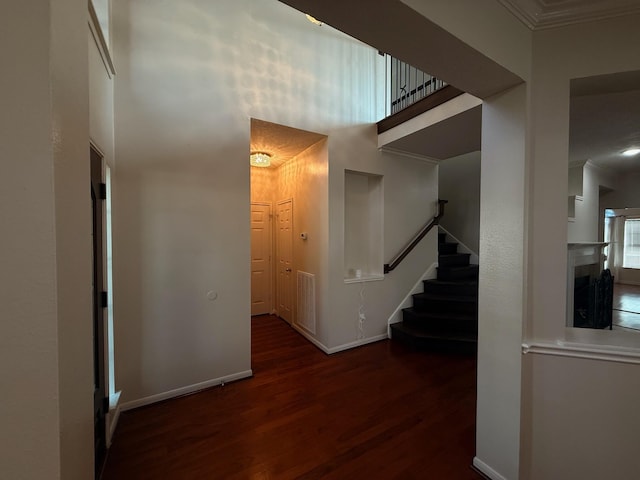 9619 Therrell Dr, Houston, TX 77064 - corridor with wood finished floors, a high ceiling, stairway, ornamental molding, and baseboards