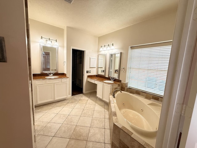 9619 Therrell Dr, Houston, TX 77064 - bathroom with a jetted tub, a textured ceiling, tile patterned floors, and two vanities