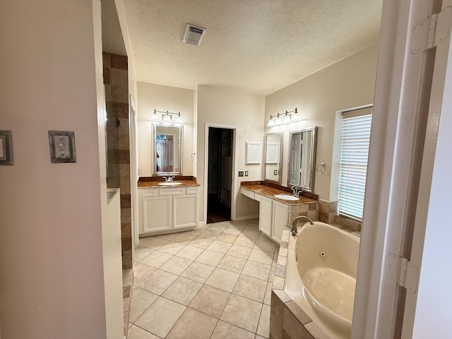 9619 Therrell Dr, Houston, TX 77064 - full bath featuring a whirlpool tub, tile patterned flooring, a walk in shower, two vanities, and a textured ceiling