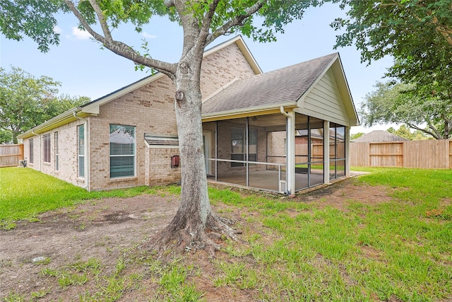 4907 Sundance Hollow Ln, Katy, TX 77494 - back of house featuring a sunroom, brick siding, and a shingled roof