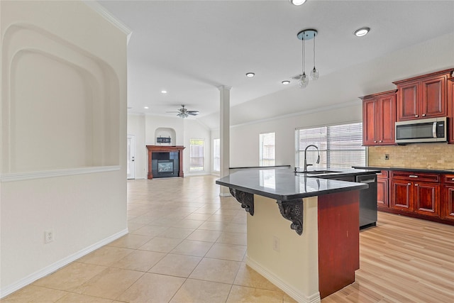 4907 Sundance Hollow Ln, Katy, TX 77494 - kitchen with dark brown cabinets, stainless steel appliances, dark countertops, tasteful backsplash, and recessed lighting