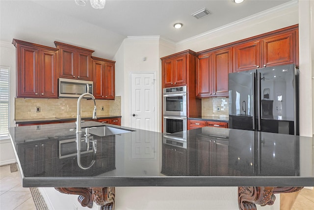 4907 Sundance Hollow Ln, Katy, TX 77494 - kitchen with stainless steel appliances, dark brown cabinets, ornamental molding, decorative backsplash, and light tile patterned floors