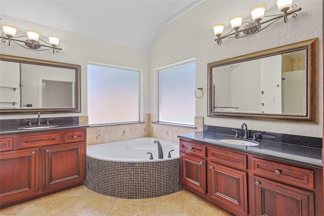 4907 Sundance Hollow Ln, Katy, TX 77494 - bathroom featuring vaulted ceiling, two vanities, a bath, and tile patterned flooring