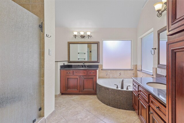 4907 Sundance Hollow Ln, Katy, TX 77494 - full bathroom featuring two vanities, a shower stall, tile patterned flooring, and a bath