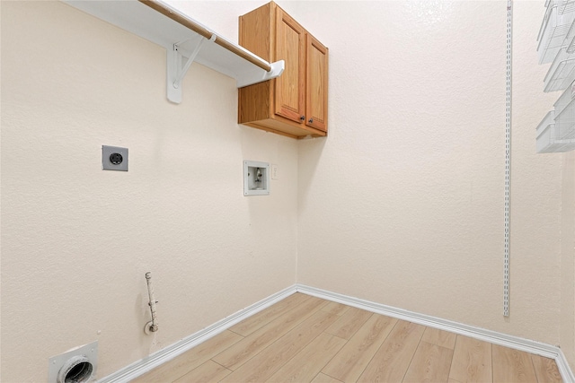 4907 Sundance Hollow Ln, Katy, TX 77494 - laundry area featuring light wood-style flooring, washer hookup, cabinet space, gas dryer hookup, and hookup for an electric dryer
