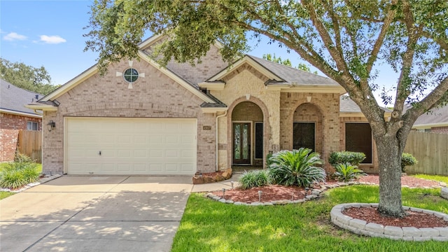 4907 Sundance Hollow Ln, Katy, TX 77494 - traditional-style house with brick siding, concrete driveway, and a garage