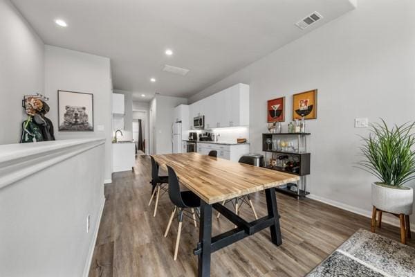 4908 Paradigm Ln, Spring, TX 77379 - dining space featuring dark wood-style floors, recessed lighting, and baseboards