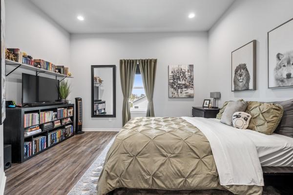 4908 Paradigm Ln, Spring, TX 77379 - bedroom featuring wood finished floors, recessed lighting, and baseboards