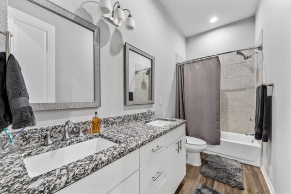 4908 Paradigm Ln, Spring, TX 77379 - bathroom with toilet, wood finished floors, double vanity, and shower / bath combination with curtain