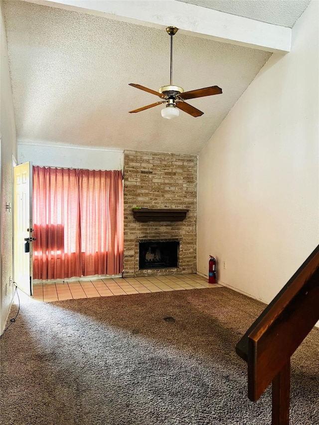 6128 Dryad Dr, Houston, TX 77035 - unfurnished living room featuring carpet floors, ceiling fan, vaulted ceiling, a textured ceiling, and a brick fireplace