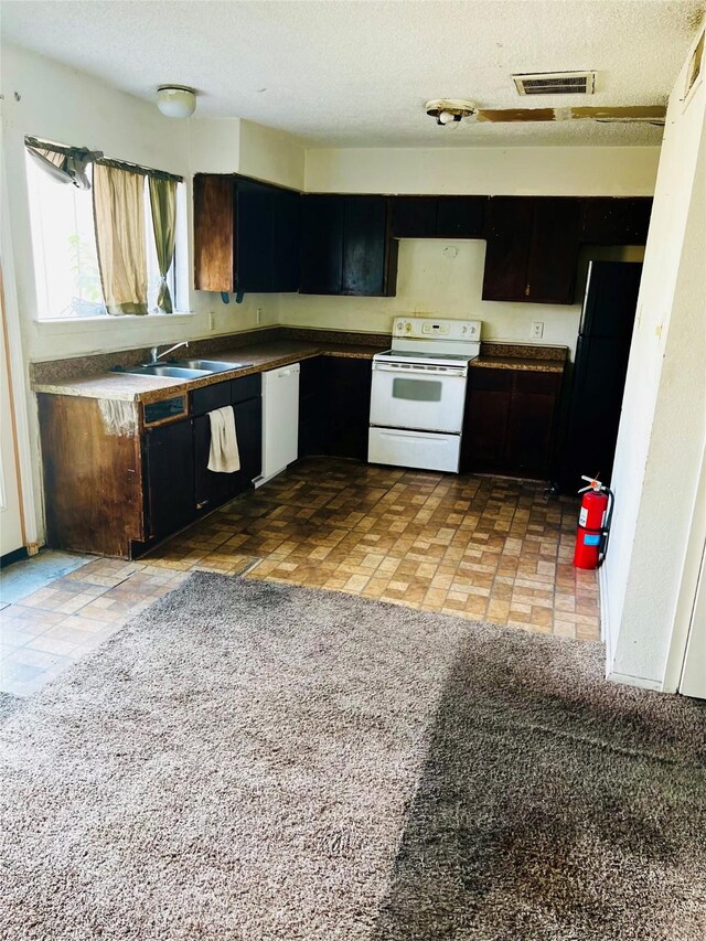 6128 Dryad Dr, Houston, TX 77035 - kitchen featuring white appliances, a sink, dark cabinets, and a textured ceiling