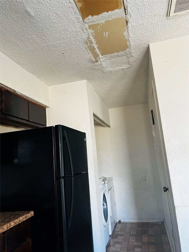 6128 Dryad Dr, Houston, TX 77035 - washroom featuring a textured ceiling, washer / clothes dryer, and baseboards