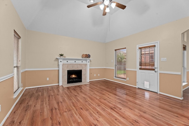 19918 Cypresswood Lake Dr, Spring, TX 77373 - unfurnished living room with ceiling fan, light wood-style floors, a fireplace, baseboards, and high vaulted ceiling
