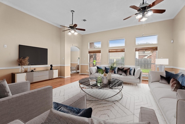 19918 Cypresswood Lake Dr, Spring, TX 77373 - living room featuring a ceiling fan, wood finished floors, arched walkways, ornamental molding, and baseboards