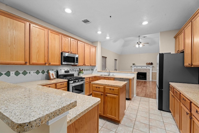 19918 Cypresswood Lake Dr, Spring, TX 77373 - kitchen with appliances with stainless steel finishes, a peninsula, a sink, light countertops, and recessed lighting