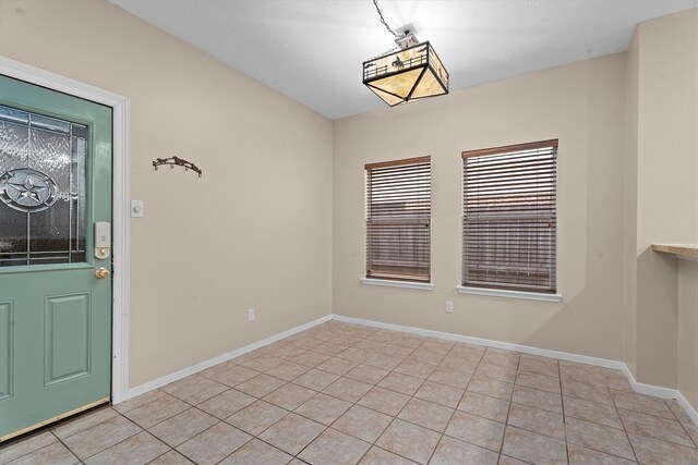 19918 Cypresswood Lake Dr, Spring, TX 77373 - unfurnished dining area with light tile patterned floors and baseboards
