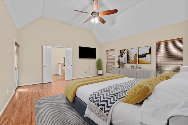 19918 Cypresswood Lake Dr, Spring, TX 77373 - bedroom with vaulted ceiling, wood finished floors, baseboards, a ceiling fan, and connected bathroom