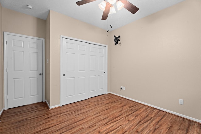 19918 Cypresswood Lake Dr, Spring, TX 77373 - unfurnished bedroom with wood finished floors, baseboards, a closet, and ceiling fan