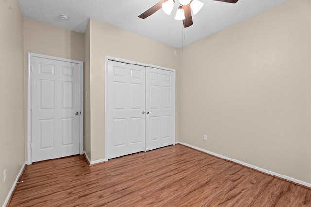 19918 Cypresswood Lake Dr, Spring, TX 77373 - unfurnished bedroom with light wood-type flooring, baseboards, a closet, and ceiling fan