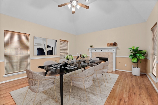 19918 Cypresswood Lake Dr, Spring, TX 77373 - dining area featuring lofted ceiling, ceiling fan, wood finished floors, a fireplace, and baseboards