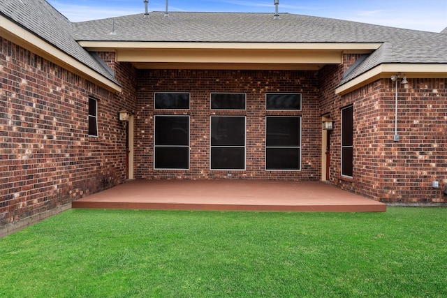 19918 Cypresswood Lake Dr, Spring, TX 77373 - rear view of property featuring brick siding, a patio area, a yard, and roof with shingles