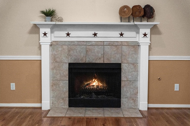 19918 Cypresswood Lake Dr, Spring, TX 77373 - detailed view of a tile fireplace, wood finished floors, and baseboards