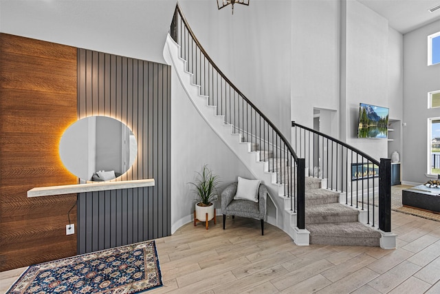 3002 Secret Lagoon Ln, Texas City, TX 77568 - stairway with a towering ceiling, wood finished floors, and baseboards