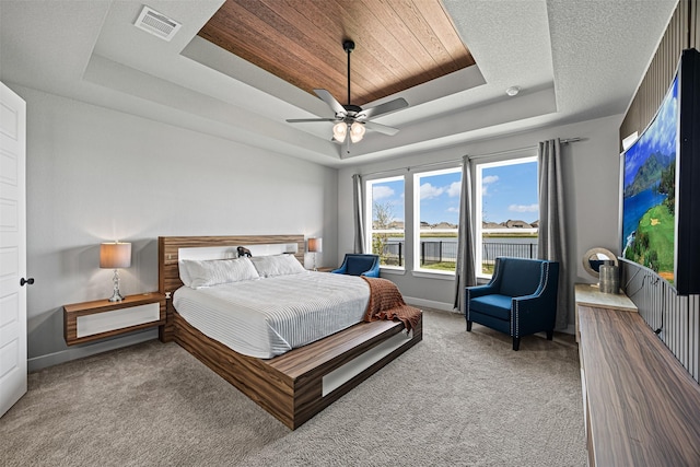 3002 Secret Lagoon Ln, Texas City, TX 77568 - bedroom with a tray ceiling, carpet, baseboards, and a ceiling fan