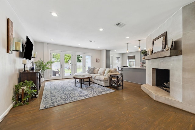 5211 Briarbend Dr, Houston, TX 77035 - living room with wood finished floors, french doors, recessed lighting, a fireplace, and baseboards