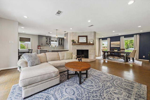 5211 Briarbend Dr, Houston, TX 77035 - living room featuring wood finished floors, baseboards, recessed lighting, and a fireplace