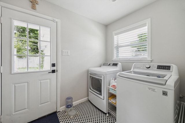 5211 Briarbend Dr, Houston, TX 77035 - laundry area featuring separate washer and dryer, baseboards, and tile patterned floors