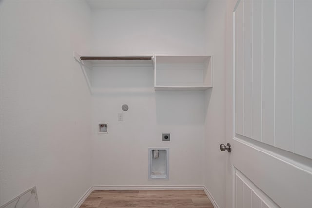 23922 Olivenza Trl, New Caney, TX 77357 - laundry room featuring hookup for an electric dryer, light wood-style flooring, hookup for a washing machine, and gas dryer hookup