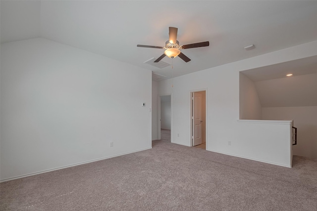 23922 Olivenza Trl, New Caney, TX 77357 - spare room featuring vaulted ceiling, a ceiling fan, light colored carpet, and attic access