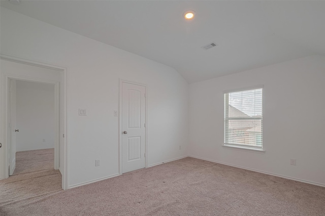 23922 Olivenza Trl, New Caney, TX 77357 - unfurnished bedroom with lofted ceiling, light colored carpet, and recessed lighting