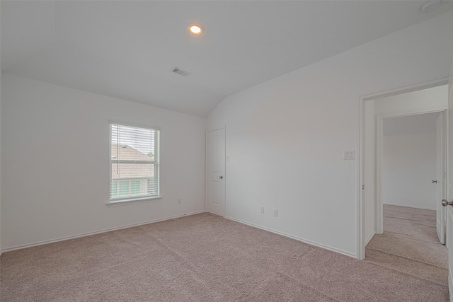 23922 Olivenza Trl, New Caney, TX 77357 - spare room with light colored carpet, lofted ceiling, and recessed lighting