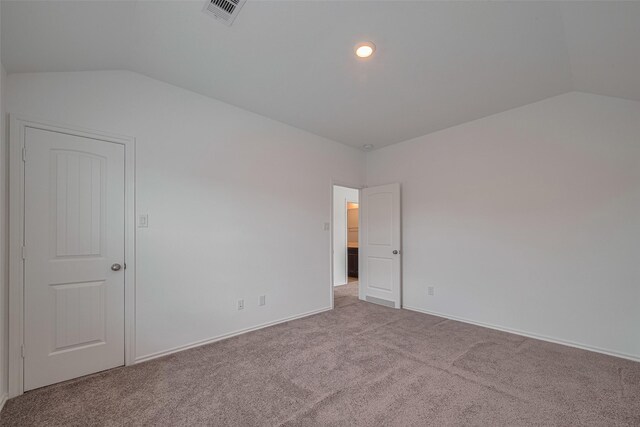 23922 Olivenza Trl, New Caney, TX 77357 - unfurnished bedroom featuring vaulted ceiling and carpet floors