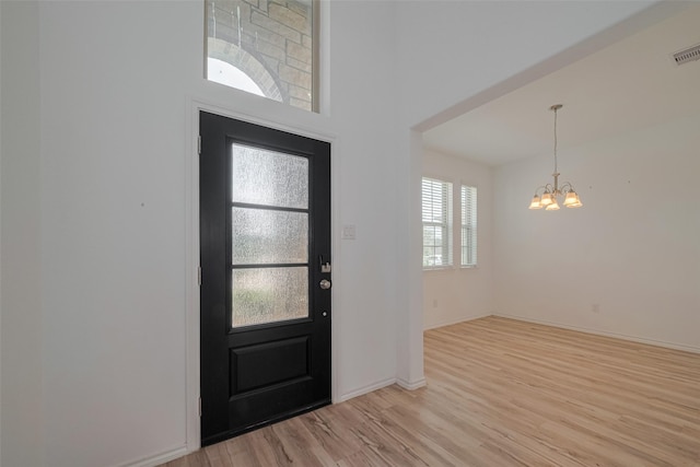 23922 Olivenza Trl, New Caney, TX 77357 - foyer featuring a chandelier and light wood finished floors