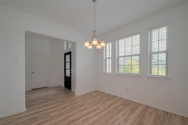 23922 Olivenza Trl, New Caney, TX 77357 - spare room with a chandelier and light wood-type flooring