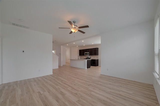 23922 Olivenza Trl, New Caney, TX 77357 - unfurnished living room featuring a ceiling fan, light wood-style floors, and recessed lighting