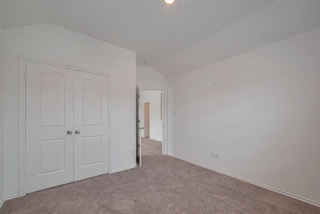 23922 Olivenza Trl, New Caney, TX 77357 - unfurnished bedroom with vaulted ceiling, carpet, and a closet