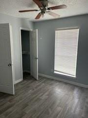 13323 S Thorntree Dr, Houston, TX 77015 - unfurnished bedroom featuring baseboards, wood finished floors, and ceiling fan