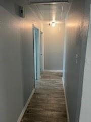 13323 S Thorntree Dr, Houston, TX 77015 - hall with attic access, baseboards, and wood finished floors